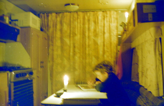 Doing homework in the caravan by candlelight